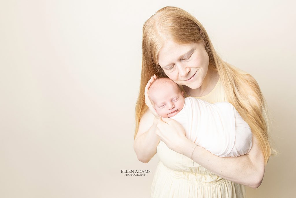 Baby photographer in Huntsville, AL Ellen Adams Photography captured this image of a mom holding her newborn baby
