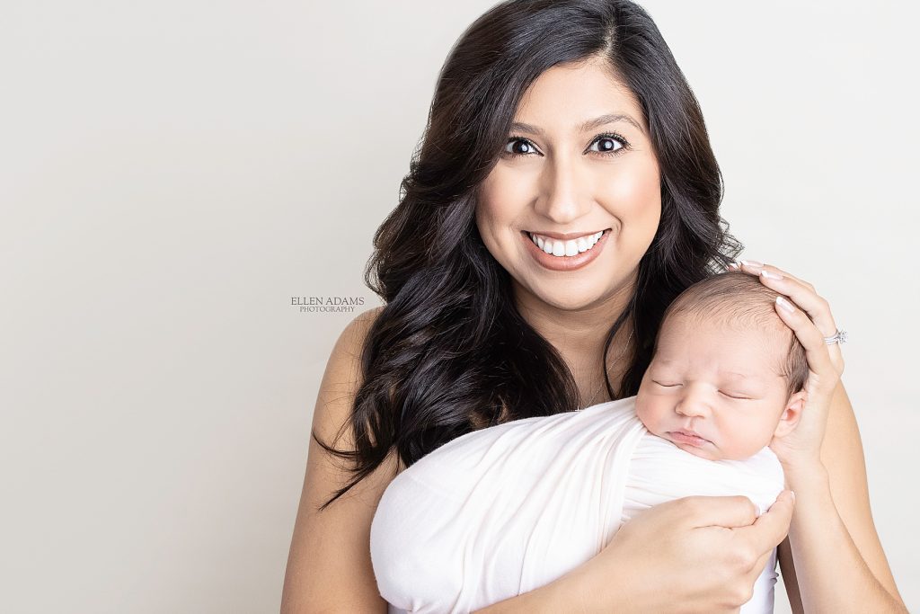Newborn photographer near me Ellen Adams Photography captured this image of a newborn baby with his mom