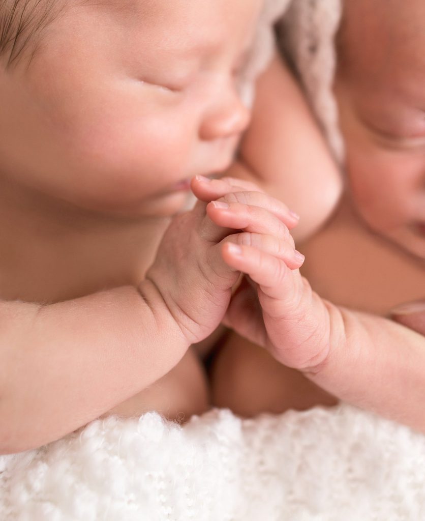 Newborn Photography Huntsville, AL image of newborn twins holding hands