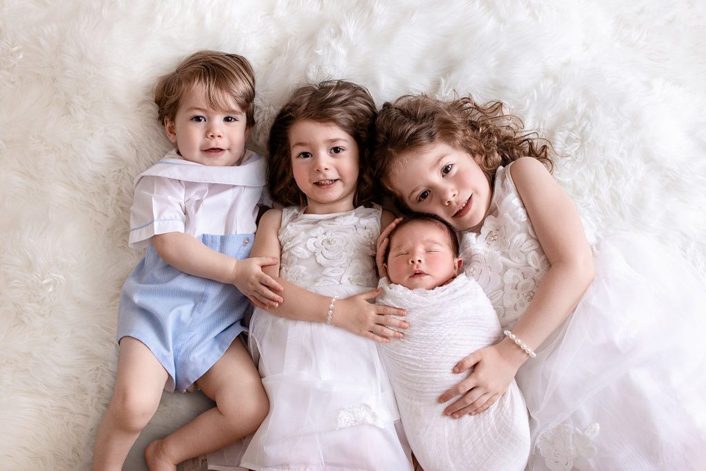 Huntsville newborn photography image of newborn with siblings by Ellen Adams Photography