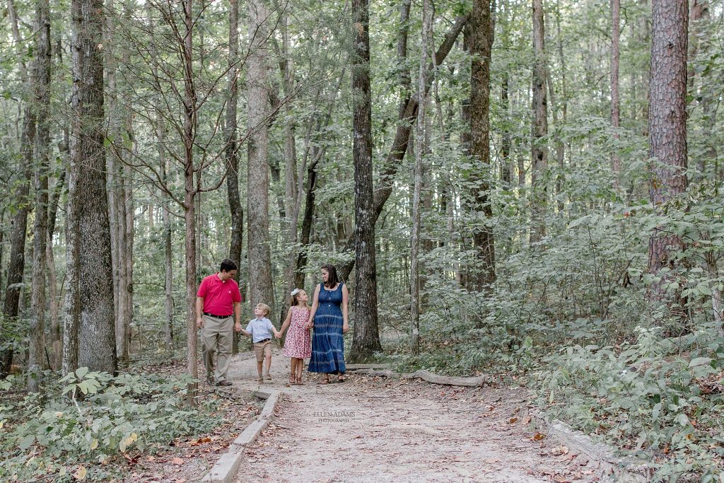 Green Mountain family photo of family walking in the woods on the nature trail.