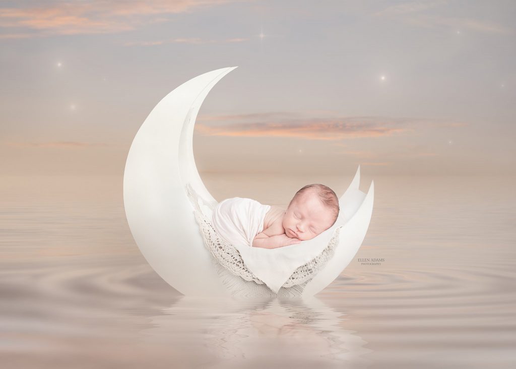 Ellen Adams Photography newborn photo of baby on a moon in a sea at sunset.