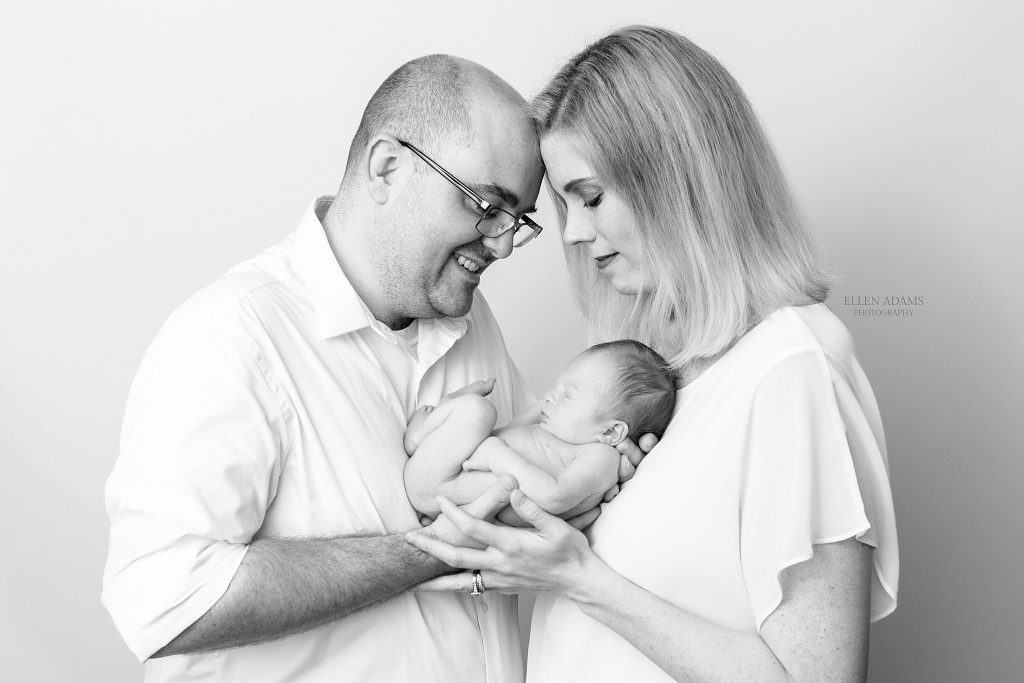 Madison AL newborn photo shoot by Ellen Adams Photography depicting a family holding their newborn.