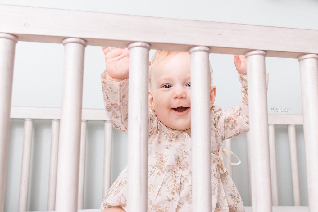 Baby in crib by Ellen Adams Photography.