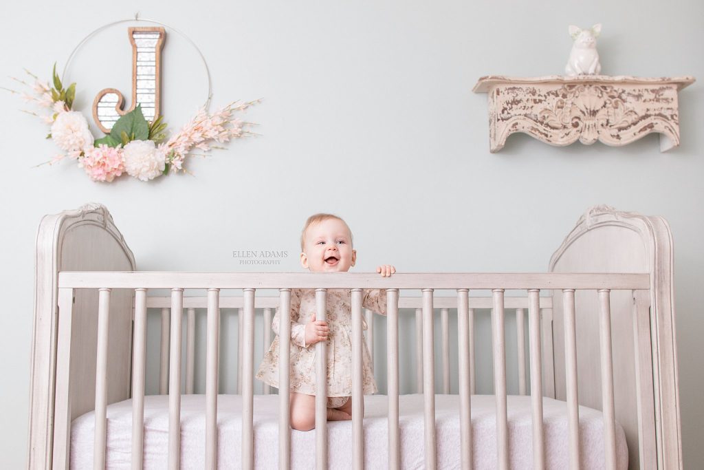 Happiest baby in her crib picture by Ellen Adams Photography.