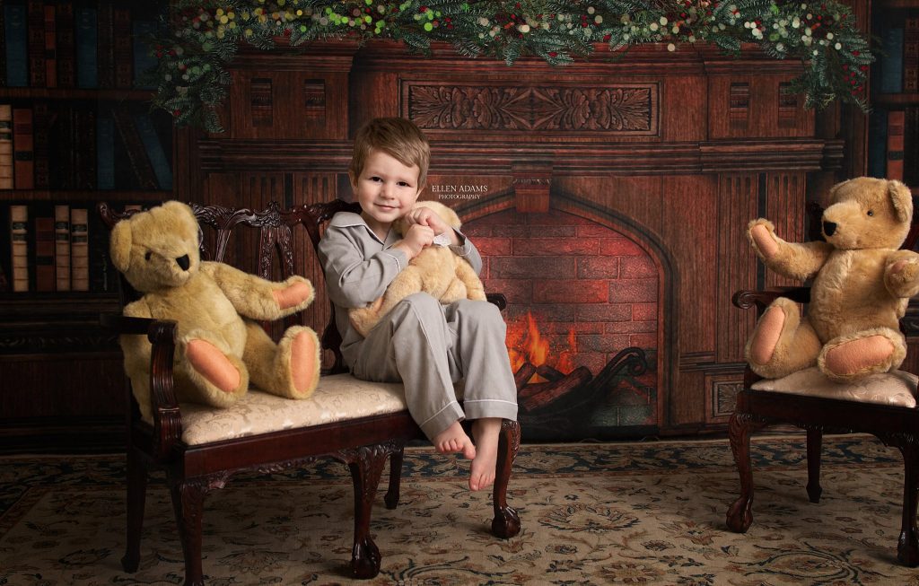 Christmas photoshoot of Huntsville Christmas Pictures by Ellen Adams Photography with a little boy hugging a teddy bear.