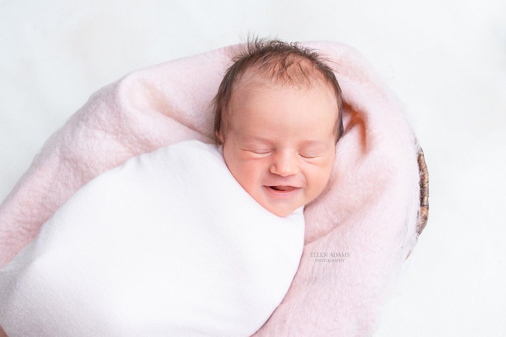 Smiling newborn photo by Ellen Adams Photography.