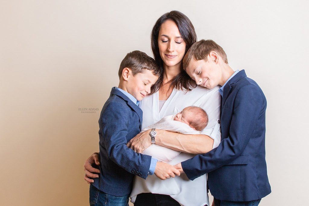 Picture of a mama holding her baby with her boys, photographed by Ellen Adams Photography in Huntsville AL.