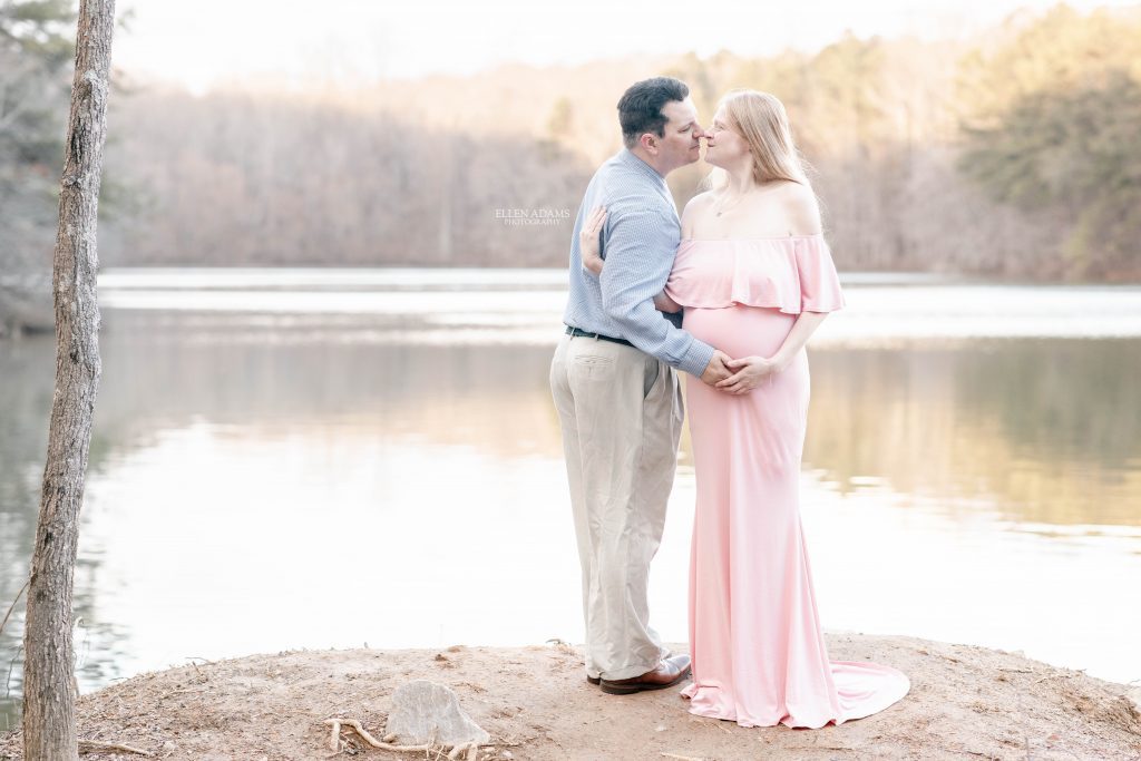 Ellen Adams Photography maternity photography in Huntsville AL picture of couple at a lake during sunset.
