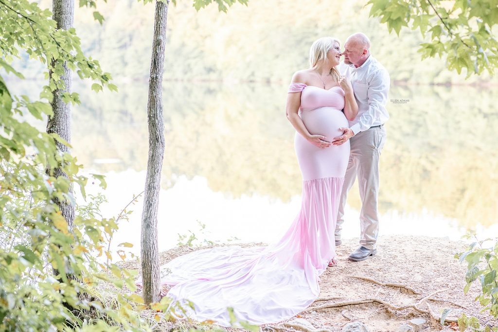 Maternity photography Huntsville image of pregnant couple by a lake in Huntsville, AL by Ellen Adams Photography.